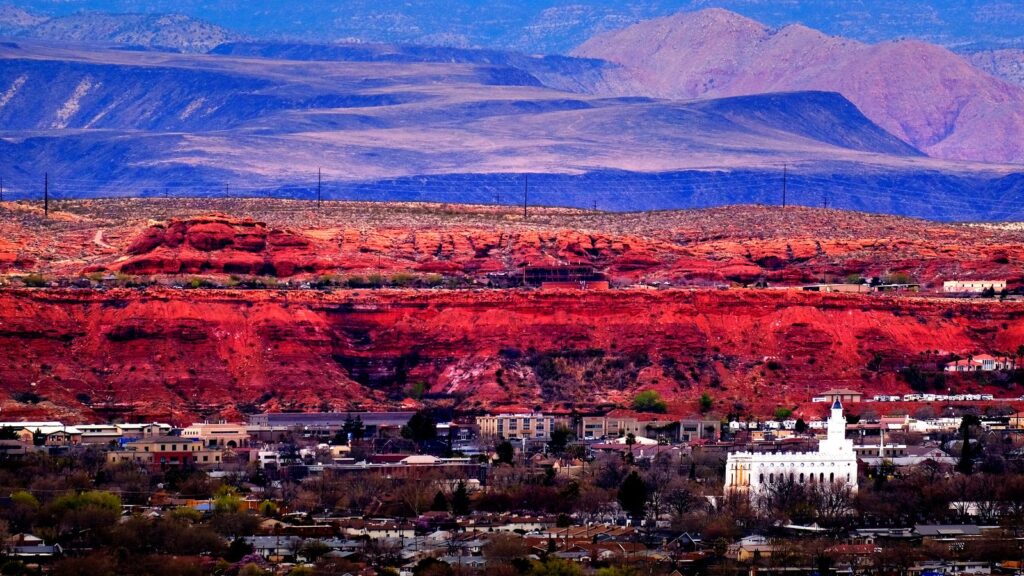 Red rock cliffs above a town in Washington County